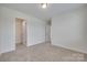 Neutral bedroom with carpet, white walls, trim and doors, closet, and overhead lighting at 5836 Clan Maclaine Dr, Charlotte, NC 28278
