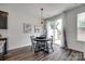Cozy dining area featuring modern lighting, neutral walls, and a sliding glass door providing backyard access at 5836 Clan Maclaine Dr, Charlotte, NC 28278