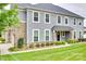Well-maintained two-story home featuring stone accents, vinyl siding, and a lush green lawn with manicured landscaping at 5836 Clan Maclaine Dr, Charlotte, NC 28278