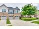 Charming home exterior with stone accents, a well-manicured lawn, and mature trees at 5836 Clan Maclaine Dr, Charlotte, NC 28278