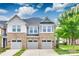 Charming townhome with stone accents, gray siding, and well-maintained landscaping, offering inviting curb appeal at 5836 Clan Maclaine Dr, Charlotte, NC 28278