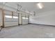 Spacious two car garage with concrete floor and white doors at 5836 Clan Maclaine Dr, Charlotte, NC 28278