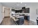 Modern kitchen with an island, granite countertops, stainless steel appliances, and dark cabinets with ample storage at 5836 Clan Maclaine Dr, Charlotte, NC 28278