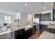 Modern kitchen boasts stainless steel appliances, granite countertops, and farmhouse sink, flowing into an open living area at 5836 Clan Maclaine Dr, Charlotte, NC 28278
