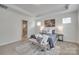Spacious main bedroom with tray ceiling, decorative rug, bench, and ensuite bathroom at 5836 Clan Maclaine Dr, Charlotte, NC 28278