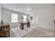 Bright office space featuring a desk, large rug, and natural light from multiple windows at 5836 Clan Maclaine Dr, Charlotte, NC 28278