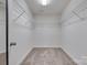 Spacious walk-in closet with carpeted floor and wire shelving for ample storage at 5836 Clan Maclaine Dr, Charlotte, NC 28278
