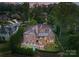 Bird's eye view of a large brick home showcasing the pool and surrounding landscape at 5915 Vidal Ln, Charlotte, NC 28226