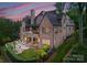 Aerial view of a home's backyard, featuring a sparkling pool, patio, and manicured lawn at 5915 Vidal Ln, Charlotte, NC 28226