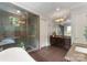 Bathroom featuring a large shower, soaking tub, tile floor, vanity with great lighting, and elegant fixtures at 5915 Vidal Ln, Charlotte, NC 28226