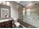 Bathroom featuring modern shower, granite countertop, dark wood vanity, and decorative tile at 5915 Vidal Ln, Charlotte, NC 28226