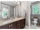 Bathroom featuring a double vanity with granite countertops, modern fixtures, and a separate glass-enclosed shower at 5915 Vidal Ln, Charlotte, NC 28226