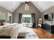 Bright bedroom featuring hardwood floors, a ceiling fan, large windows, and elegant seating for a relaxing space at 5915 Vidal Ln, Charlotte, NC 28226