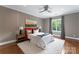 Spacious bedroom with a gray accent wall, hardwood floors, and plenty of natural light at 5915 Vidal Ln, Charlotte, NC 28226