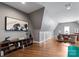 Spacious bonus room with hardwood floors and a cozy seating area at 5915 Vidal Ln, Charlotte, NC 28226