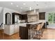 Kitchen with eat-in bar, stainless steel appliances, granite countertops, and custom cabinetry at 5915 Vidal Ln, Charlotte, NC 28226
