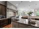 Gourmet kitchen with custom cabinetry, stainless steel appliances, large island, and views to backyard at 5915 Vidal Ln, Charlotte, NC 28226