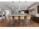 Open kitchen with granite countertops, pendant lighting, stainless appliances, and seating for four at the island at 5915 Vidal Ln, Charlotte, NC 28226