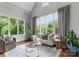 Bright living room with hardwood floors, large windows with natural light, and elegant furnishings at 5915 Vidal Ln, Charlotte, NC 28226