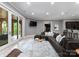 Cozy basement living room featuring a large sectional, TV, and access to an outdoor patio at 5915 Vidal Ln, Charlotte, NC 28226