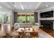 The living room features a fireplace, coffered ceilings, and large windows with backyard views at 5915 Vidal Ln, Charlotte, NC 28226