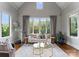 Bright living room with hardwood floors, large windows with natural light, and elegant furnishings at 5915 Vidal Ln, Charlotte, NC 28226
