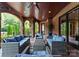 Beautiful outdoor patio featuring stone arches, wood ceilings, elegant seating, and a beautiful backyard at 5915 Vidal Ln, Charlotte, NC 28226