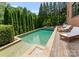 Relaxing pool area surrounded by lush greenery and lounge chairs, perfect for summer days at 5915 Vidal Ln, Charlotte, NC 28226