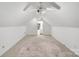 Bright attic with slanted ceilings, carpet flooring, neutral walls, and an ensuite bathroom at 592 Woodcrest Dr, Gastonia, NC 28056