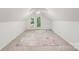 Bright attic featuring carpet, slanted ceilings, natural light, and access to a balcony at 592 Woodcrest Dr, Gastonia, NC 28056