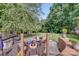 Landscaped backyard featuring a fire pit, hammock, and outdoor seating for relaxing and entertaining at 592 Woodcrest Dr, Gastonia, NC 28056