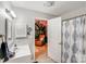 Bright bathroom with a white vanity, updated fixtures, and an adjoining room with a mural at 592 Woodcrest Dr, Gastonia, NC 28056