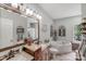 Well-lit bathroom features double sinks and an inviting soaking tub, creating a spa-like retreat at 592 Woodcrest Dr, Gastonia, NC 28056