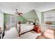Cozy bedroom with sloped ceilings, a ceiling fan, carpet, and two windows offering natural light at 592 Woodcrest Dr, Gastonia, NC 28056