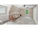 Spacious bonus room with carpet flooring, natural light, ceiling fan, and furniture at 592 Woodcrest Dr, Gastonia, NC 28056