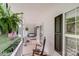 Relaxing covered porch with a swing, rocking chair and hanging fern at 592 Woodcrest Dr, Gastonia, NC 28056