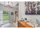 Inviting entryway with tile floor, wood accents, modern lighting fixture, and beautiful artwork at 592 Woodcrest Dr, Gastonia, NC 28056