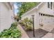Exterior view of the house and detached garage connected by a brick pathway and lush landscaping at 592 Woodcrest Dr, Gastonia, NC 28056