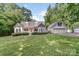 Charming home with a lush front yard, a welcoming porch, and a detached garage at 592 Woodcrest Dr, Gastonia, NC 28056