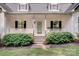 Inviting front porch with decorative plants and cozy seating, leading to the main entrance at 592 Woodcrest Dr, Gastonia, NC 28056