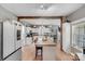 Bright kitchen features a central island with bar stool seating and white cabinets, promoting a seamless culinary experience at 592 Woodcrest Dr, Gastonia, NC 28056