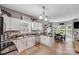 Spacious kitchen with white cabinetry, eat-in island, and adjacent dining area with backyard view at 592 Woodcrest Dr, Gastonia, NC 28056