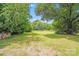 Expansive backyard with mature trees and lush greenery, offering privacy and space at 6300 Mount Pleasant S Rd, Concord, NC 28025