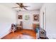 Well-lit bedroom with hardwood floors, large window, and ample space for storage at 6300 Mount Pleasant S Rd, Concord, NC 28025