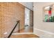 Inviting entryway with brick accent wall, tile floor, and view of the kitchen at 6300 Mount Pleasant S Rd, Concord, NC 28025