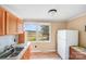 Cozy kitchen with stainless steel sink, light wood cabinets, tile flooring and a window overlooking the backyard at 6300 Mount Pleasant S Rd, Concord, NC 28025