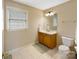 Cozy bathroom featuring tile floors, a vanity, and a toilet at 6409 Barkley Farm Rd, Huntersville, NC 28078