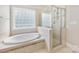 Bright primary bath with separate tub and glass enclosed shower at 6409 Barkley Farm Rd, Huntersville, NC 28078