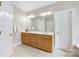 Primary bathroom features a double sink vanity and tiled floors at 6409 Barkley Farm Rd, Huntersville, NC 28078
