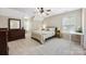 Bedroom with neutral walls and carpet offers ample sunlight at 6409 Barkley Farm Rd, Huntersville, NC 28078
